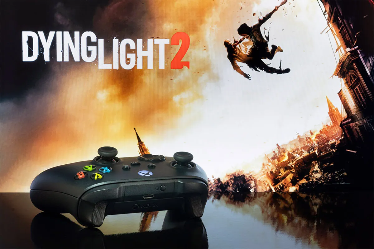 Xbox Series controller with Dying Light 2 game at background.