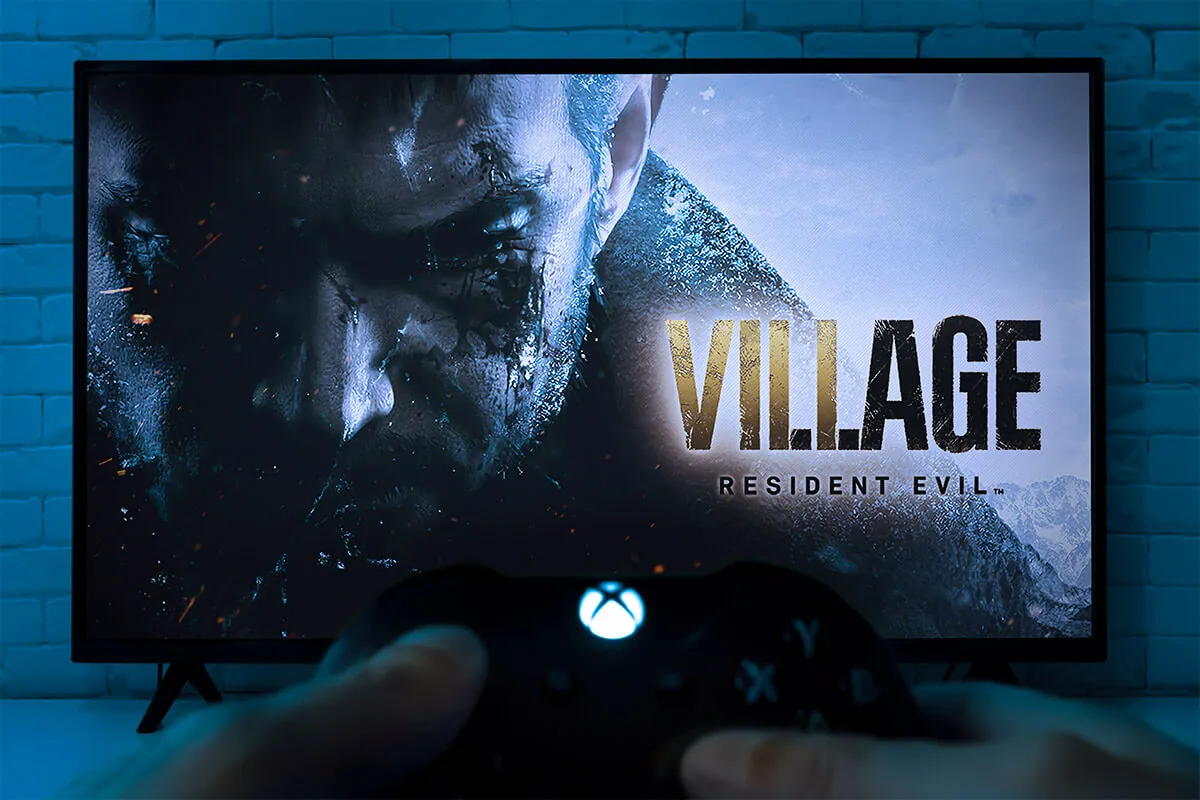 Man play Resident Evil Village on TV